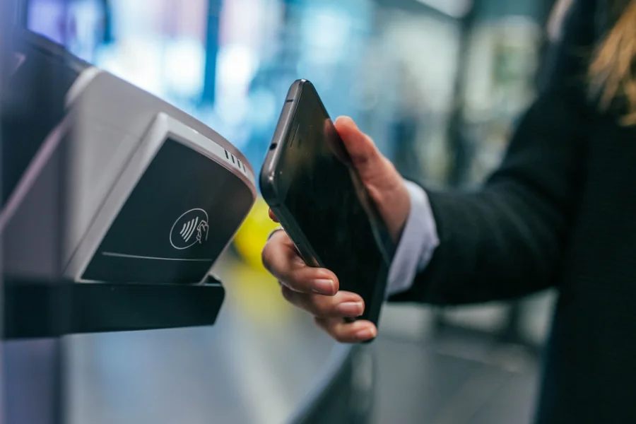 Customer making a contactless payment at a point-of-sale terminal
